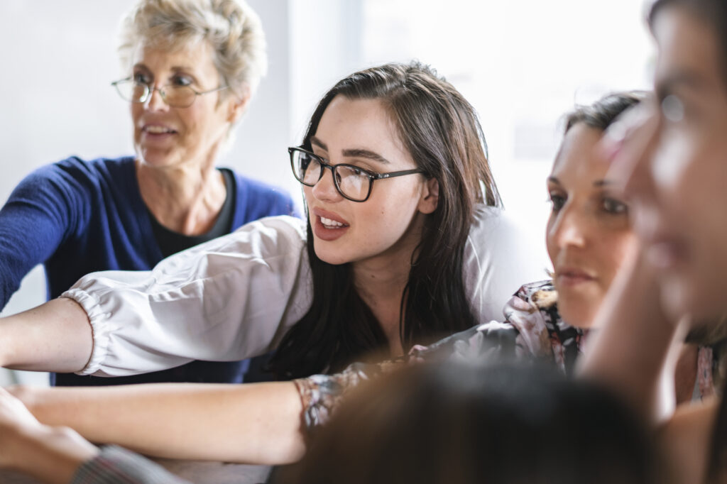 A young woman talking to business mentors for professional growth